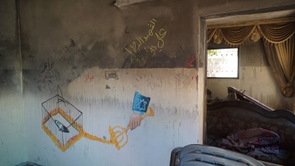 Artwork inside the burned-out Dawabshe home blames the Israeli government for the firebombing. (Photo: Dan Cohen) 