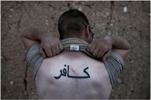 U.S. ARMY 10th Mountain Division soldier in Wardak Providence, Afghanistan, 2009. “Kafir” tattoo