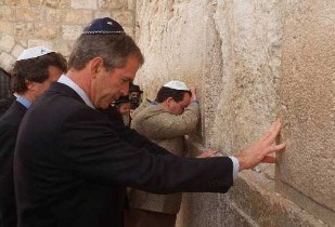 President George Bush wearing a yarmulke as he prays at the Western Wall