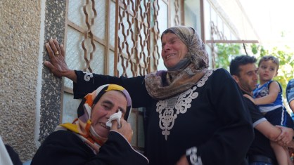 The mother of Sa’ad Dawabshe and a relative grieve. (Photo: Dan Cohen) 